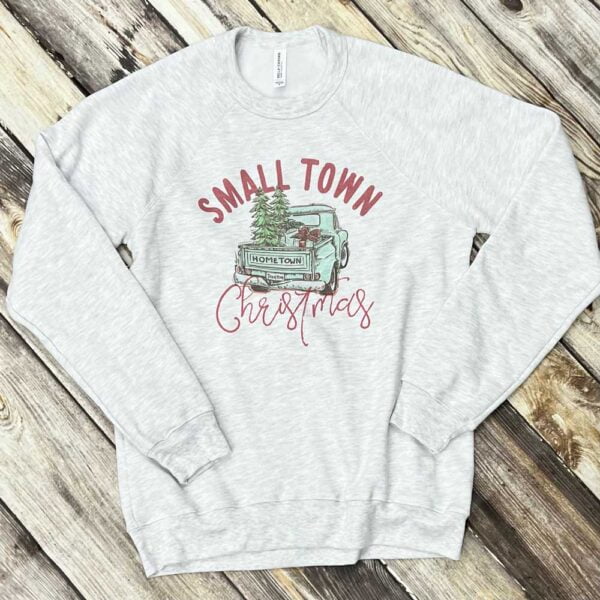 Featuring an old-timey truck, this Small Town Christmas sweatshirt is perfect to keep you warm during this holiday season.